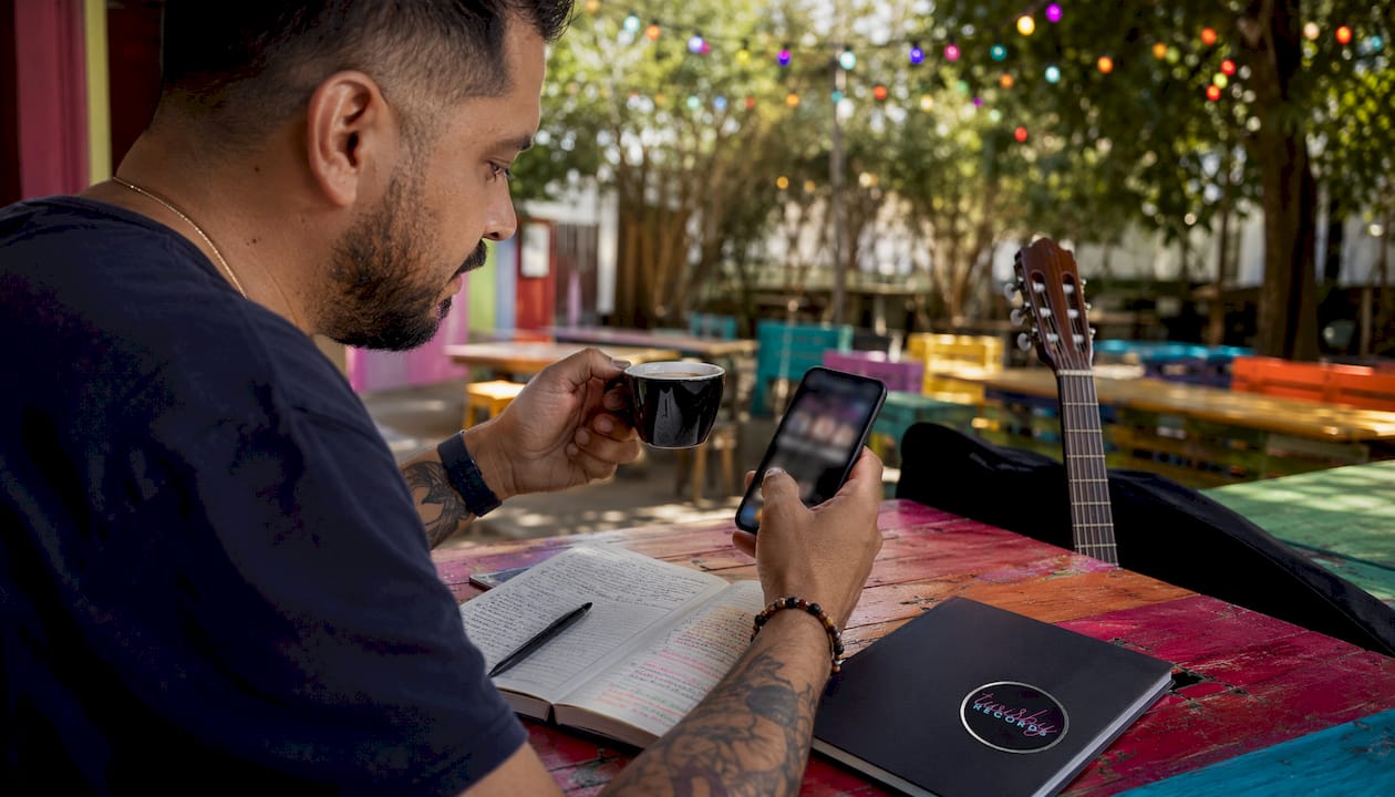 Musician using smartphone with social music apps