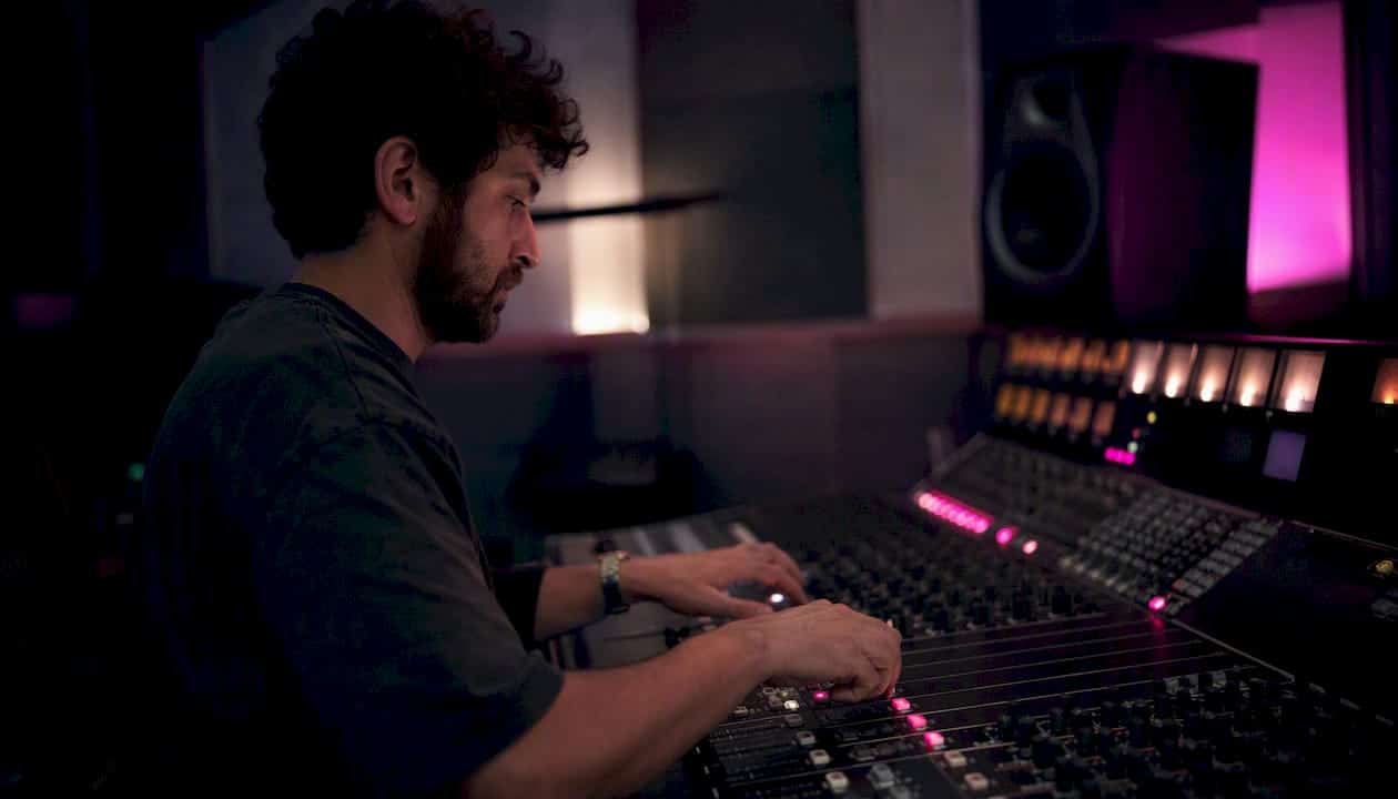 Partial stereo mixing console with hands adjusting