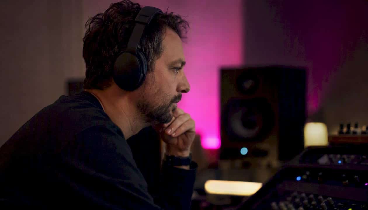 Mastering engineer listening intently with headphones