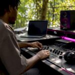 Hands embedding ISRC code in audio mastering
