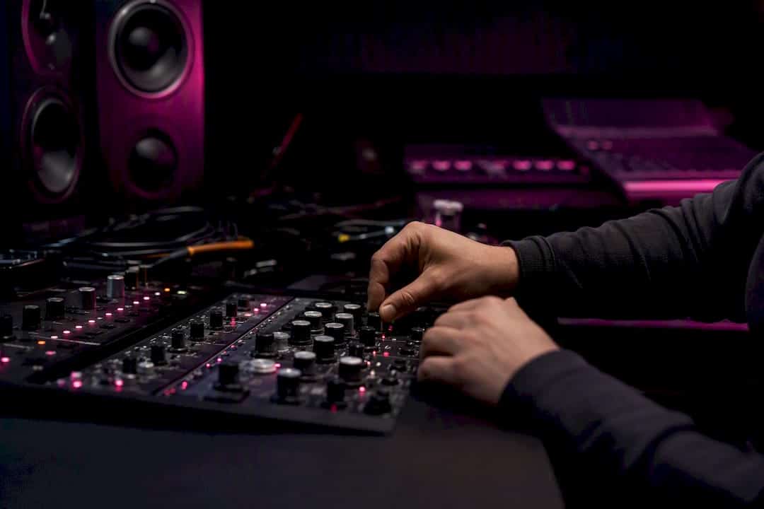 Hands connecting cables in studio desk