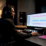 Engineer comparing audio mixes during online approval