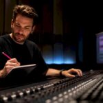 Engineer reviewing mix revisions in studio
