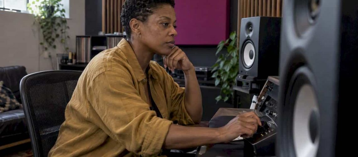 Mastering engineer listening in a studio